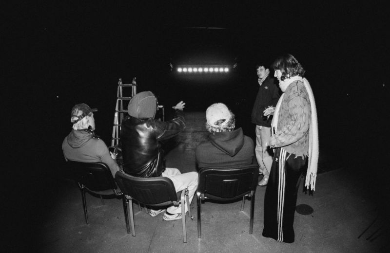 Fem personer samlade i en mörk lokal framför en upplyst scenkant.