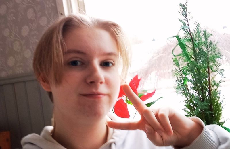 En selfie på Liam som gör ett fredstecken med fingrarna i en vardagsmiljö